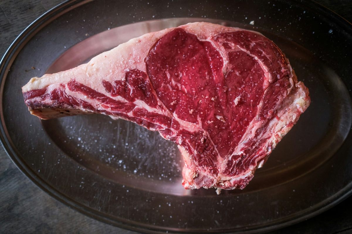 Raw bone-in beef rib steak (sample photo)
